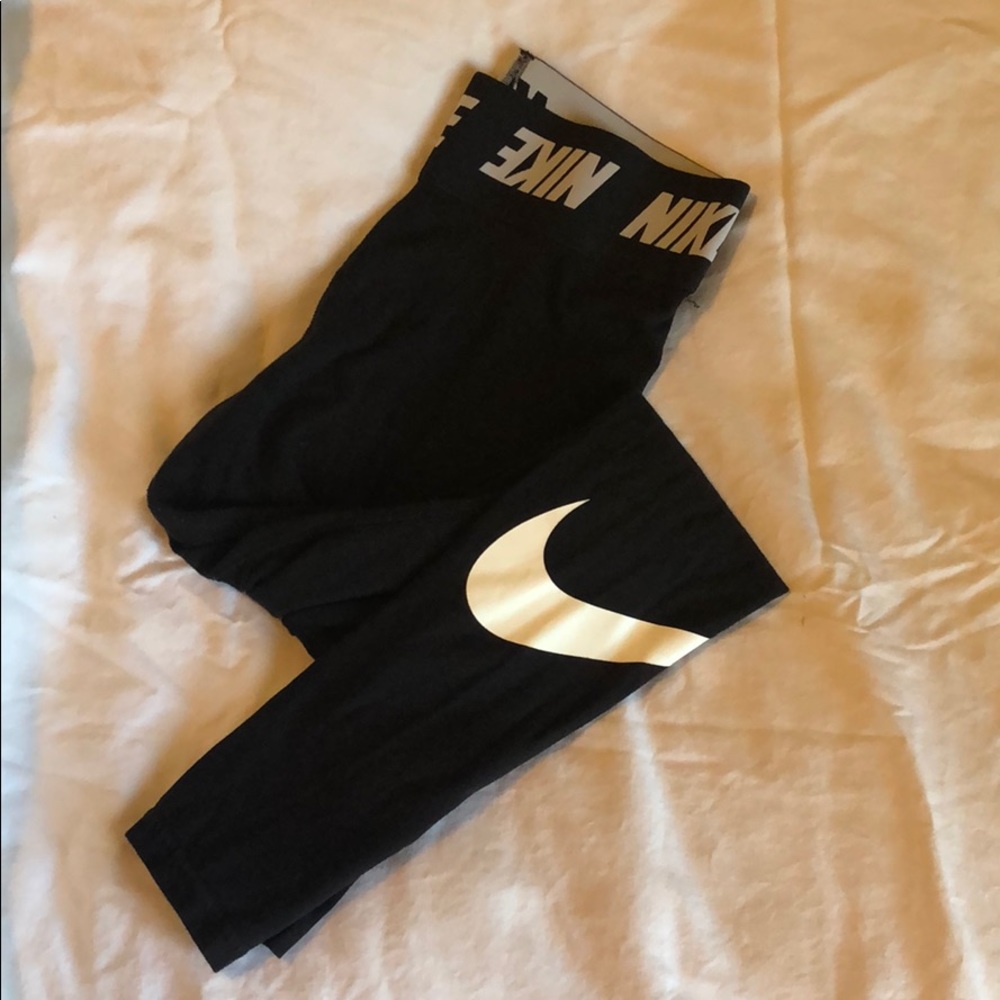Nike women’s black leggings with white Nike check